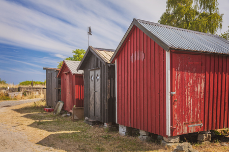 Red fishing huts on the beach in Vik, Sweden.の写真素材