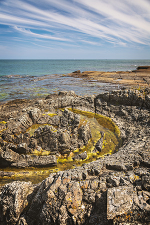 Circular geological feature on rocky beach. Vik, Sweden.の写真素材