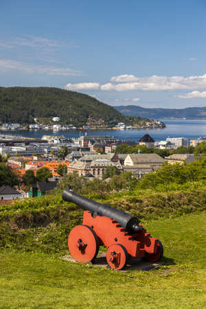View of the city of Trondheim, Norway. A historic cannon in the foreground.の写真素材