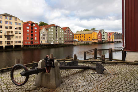Ships anchor and colourful buildingsby the river Nidelva. Trondheim, Norway.の写真素材