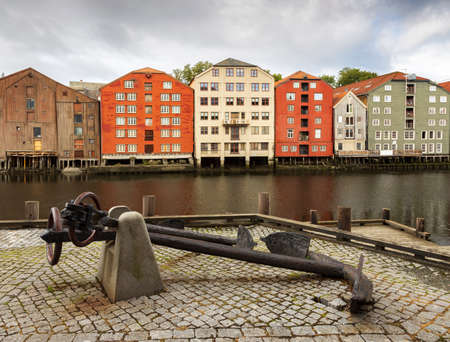 Ships anchor and colourful buildingsby the river Nidelva. Trondheim, Norway.の写真素材