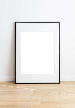 Rectangular mock up standing in a room with wooden flooring and white wall.の写真素材