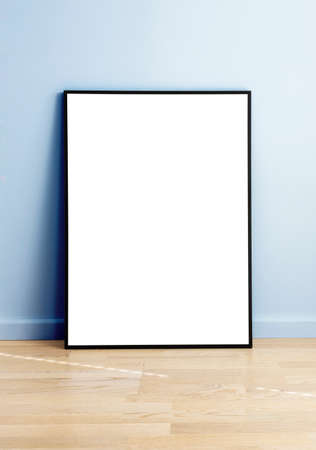 Rectangular mock up standing in a room with wooden flooring and blue wall.の写真素材