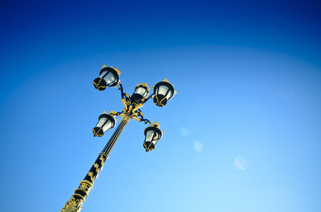 Old style street lights of Madrid with skylineの写真素材