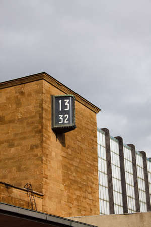 A clock on the wall of Florence train stationの写真素材