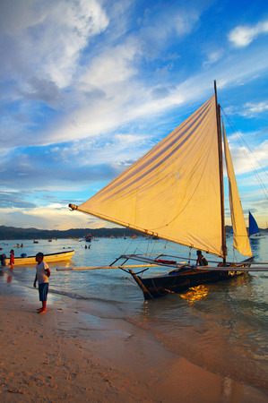 Yacht Sailing against sunset. のeditorial素材