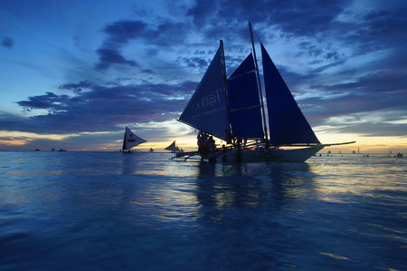 Yacht Sailing against sunset.のeditorial素材