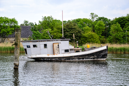 Black and white house boat anchor on the canal in Copenhagen at summertimeの写真素材
