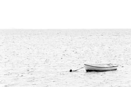 Black and white image of a white boat on the sea on the way to Thisted, Denmarkの写真素材