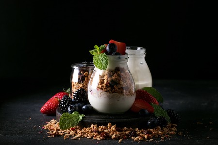 Homemade granola breakfast served with berries, yoghurt and decorated with mint leaves. Rustic breakfast Conceptの写真素材