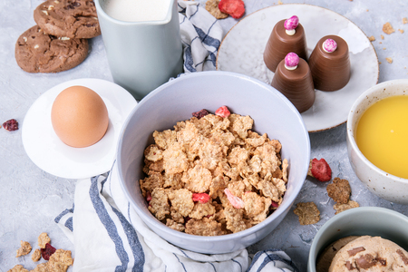 Home made crunch breakfast. Served with chocolate drop cookies, an egg, a glass of organic milk and orange juice. Top viewの写真素材
