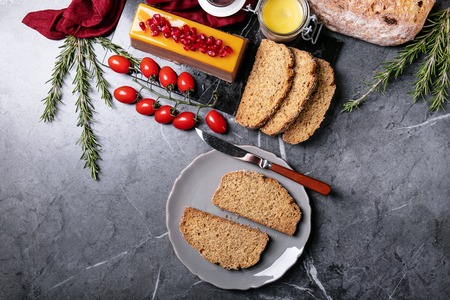 Home made liver pate served on sourdough bread with pomegranate seeds, rosemary and cherry tomatoes. Top Viewの写真素材