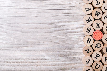 Wooden letters over gray wooden background. Top view, flat lay. Copy space