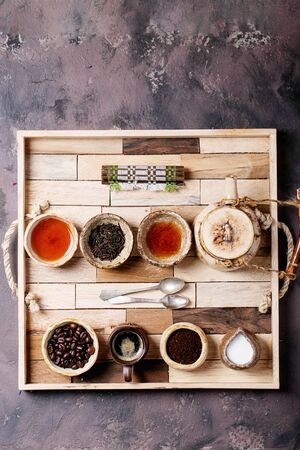 Black tea in a ceramic cup versus espresso coffee over a brown texture background. Top view. Copy Spaceの写真素材