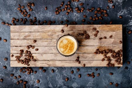 Bulletproof coffee served with ground and whole coffee beans, coconuts, coconut oil over dark texture background. Top view, flat lay. Copy spaceの写真素材