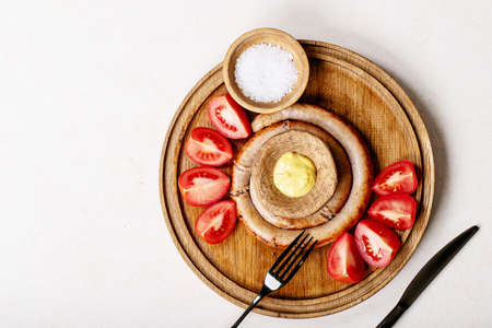 Grilled snail sausage in traditional spiral on dark texture background. Top view, flat lay. Copy spaceの写真素材