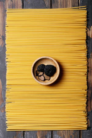 Home made egg pasta served with truffles, truffle infused oil and salt. New concept of raw foods. Top view, flat lay. Copy spaceの写真素材