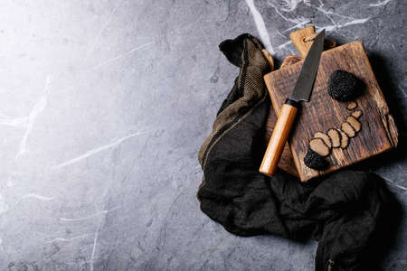 Truffle mushroom served with truffle infused olive oil and sea salt with truffles over a black texture background. Top View, flat lay. Copy spaceの写真素材