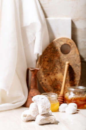 Traditional Greek sweet cookies kourabiedes in sugar powder over white marble background. Top view, flat layの写真素材