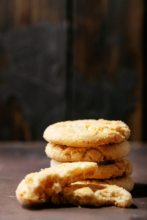 Homemade white chocolate chunk cookies over brown texture background