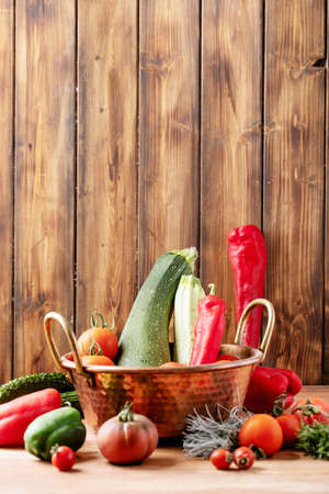 Fresh red tomatoes over brown wooden background. Top view, flat lay. Copy spaceの写真素材