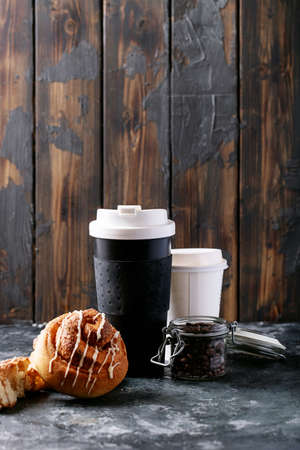 Baked cinnamon buns served with cinnamon and coffee over white texture background. Take away conceptの写真素材