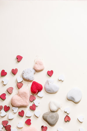 Valentines day background with small red and white wooden hearts over white background. Top view, flat lay. Copy spaceの写真素材