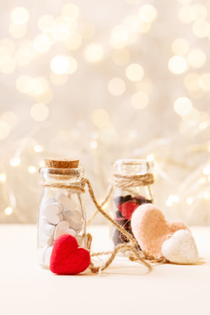 Valentines day background with small red and white wooden hearts over white background. Copy spaceの写真素材