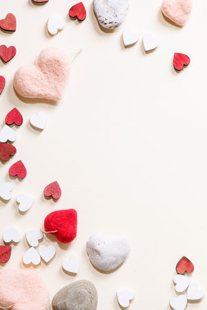 Valentines day background with small red and white wooden hearts over white background. Top view, flat lay. Copy spaceの写真素材
