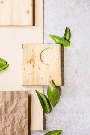 Fresh oranges with green leaves on white papper and wooden desks. Top view, flat lay. Copy spaceの写真素材