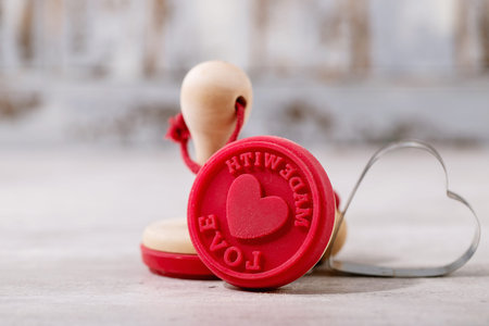 St. Valentines Day stamp for cookies over bright wooden backgroundの写真素材
