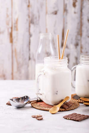 Vanilla milkshake served with chocolate over white texture backgroundの写真素材