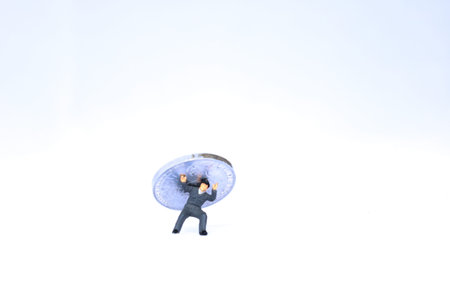 The coin was on top of the miniature men