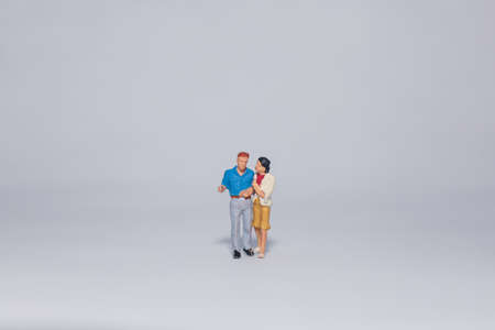 Miniature couple talking, isolated om white backgroundの写真素材