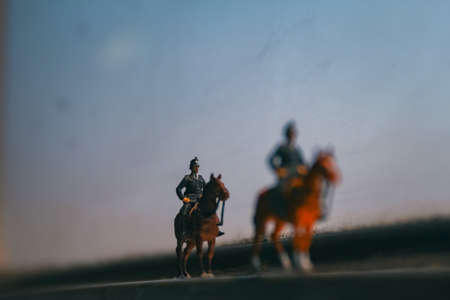 Two miniature mounted police  at the edge of a window during duskの写真素材