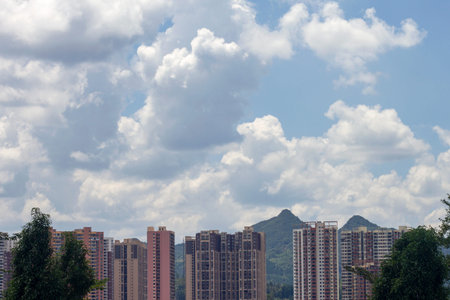 high rise buildings under the blue sky and white clouds in hong kongの写真素材