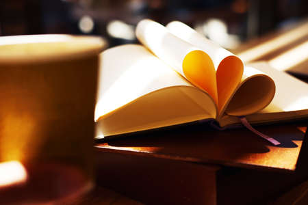 Notebook with violet flowers on a wooden abstract background.Book opens with a purse on a wooden background.の写真素材