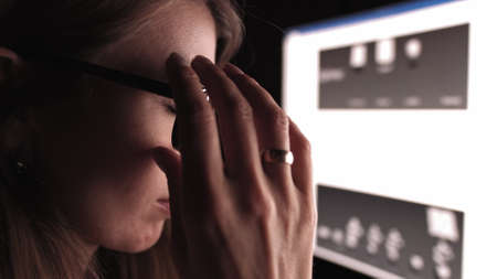 Overworked Tired Businesswoman Working Late Night At Deadline.Girl Worker Office At Night.Employee Woman Overtime Work.Exhausted Businesswoman Computer PC Remote Chatting Webinar.Internet Online Job.の写真素材