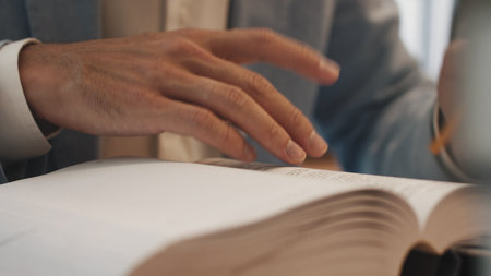Businessman hands working in stacks of paper files for searching information on work desk office,...