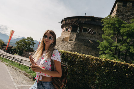 Beautiful portrait of a smiling young girl in stylish glasses.Traveling girl with a backpack on his...