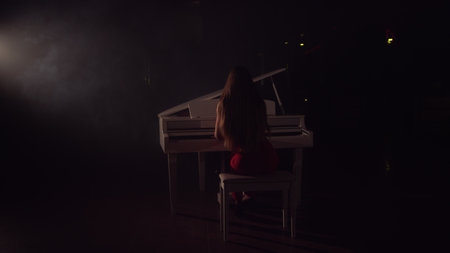 4K Footage Of Female Pianist Plays In Beautiful Grand Piano On Stage In Concert . A woman plays the...