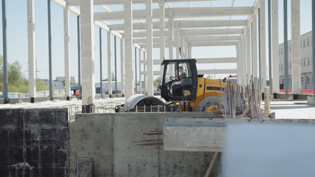 Ground hardening by heavy construction machinery rollers road and factory construction. Loader...