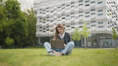 Happy university teenager girl female student. Young woman receiving good news on laptop. student celebrating exams, admission to College, business great results win success victoryの写真素材