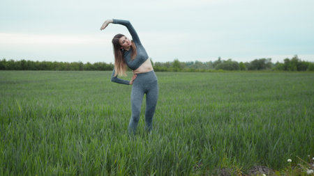 Woman Stretching And Warming-Up Before Running.Athlete Female Training In Sportswear And Warm-Up.Fitness Runner Woman Workout Outdoor.Girl Limbering-Up And Stretching Arms After Running Jog Workout.の写真素材