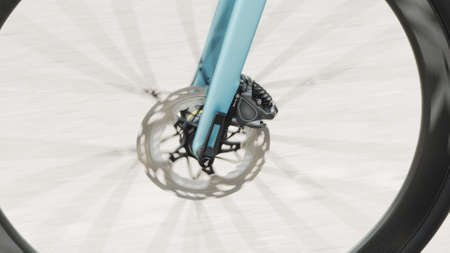 The bicycle wheel is spinning. Glare of the sun through the spokes of the bicycle wheel. Bicycle wheel rotation. Cyclist training. Sports Healthy lifestyle.の写真素材