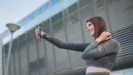 Close up of the young caucasian woman having a video chat on the modern building background....
