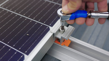 Close up of worker installing and working on maintenance of photovoltaic panel system installed....