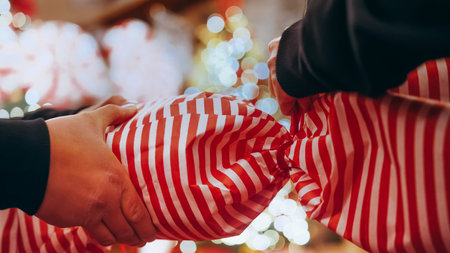 Close up of female hands making a big Christmas decoration in the form of candies in a Christmas...
