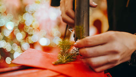 Close up of making beautiful red letters for Santa Claus with Christmas decor. Making decorations in the store for the New Year or Christmas. Letters or envelope for Santa Claus.の写真素材