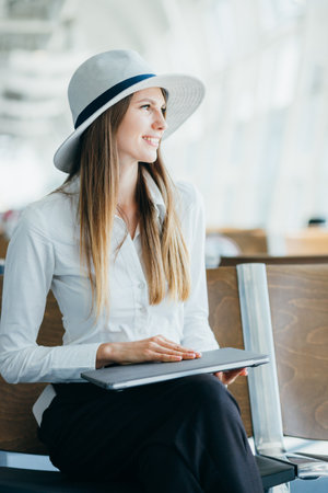 Beautiful and elegant businesswoman working on a computer on an airportの写真素材